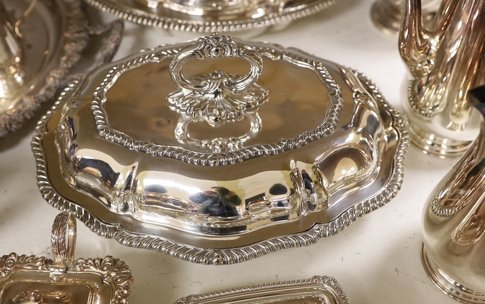 A large quantity of plated wares including two entree dishes and covers, a three-piece tea set etc.